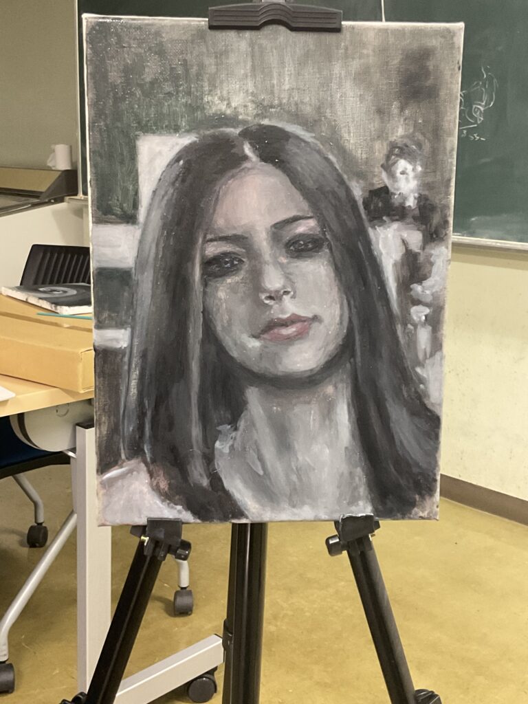 黒上長髪の西洋風の女性の絵画である。
右奥には、男性も描かれている。